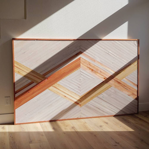 Natural wood and white painted geometric headboard wall art.